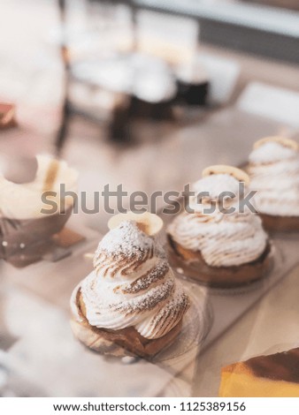 Tartlet with Italian meringue and lemon cream on a wooden stand, selective focus.