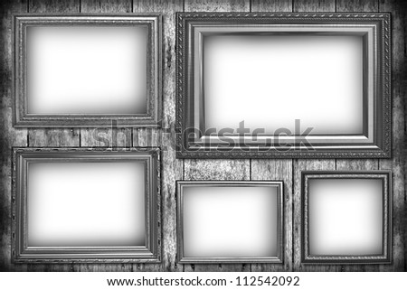 Wooden photo frame on old wooden wall in black and white.