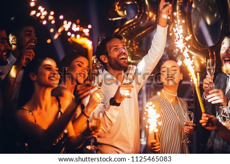 Group of friends celebrating with champagne Royalty-Free Stock Photo #1125465083