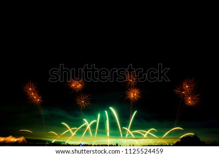 little people on the background of a huge Colorful fireworks