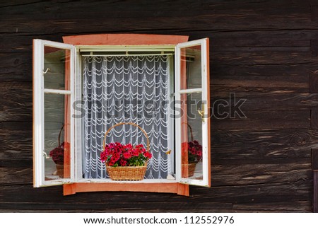 window decorated with flower on wooden wall