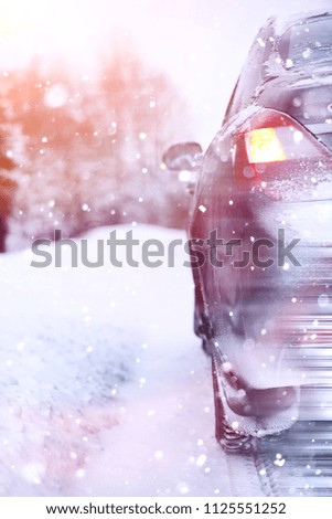 The car stands on a snow-covered road