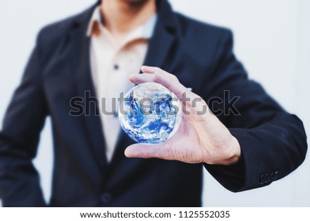 Businessman holding in hand with global connection concept. Earth image provided by Nasa.