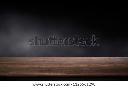 Old wood table on dark background. 