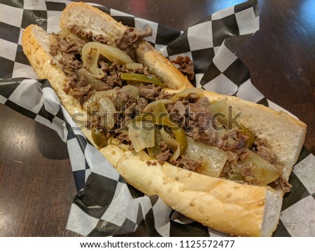 Hot Greasy, Philly Cheesteak Topped with Grilled Onion, Peppers and Cheese