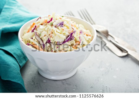 Traditional cole slaw salad in a white bowl Royalty-Free Stock Photo #1125576626