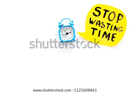 Stop wasting time hand letterng near alarm clock on white background top view copy space. Business concept, motivation