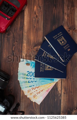 Stack of israeli money bills of 200 shekel and israeli passport