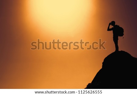 Silhouette of a climber outdoor on summit with copy space as symbol for success