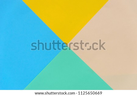 background of colorful paper triangles of pastel colors - yellow, beige, green, blue