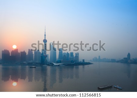 shanghai skyline and reflection in sunrise