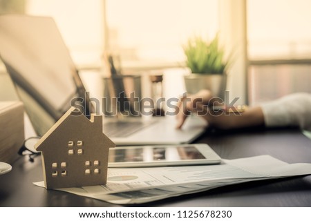 Hand of Business people calculating interest, taxes and profits to invest in real estate and home buying Royalty-Free Stock Photo #1125678230