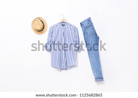 striped clothes on hanging with blue jeans ,hat white background
