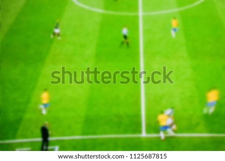 Soccer players at the pitch. Blurred soccer game.