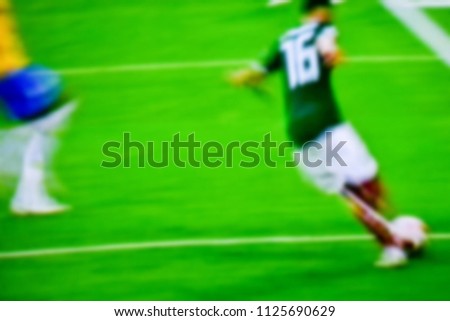 Soccer players at the pitch. Blurred soccer game.

