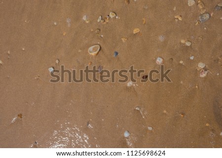 Stones and grains of sand on a beach.