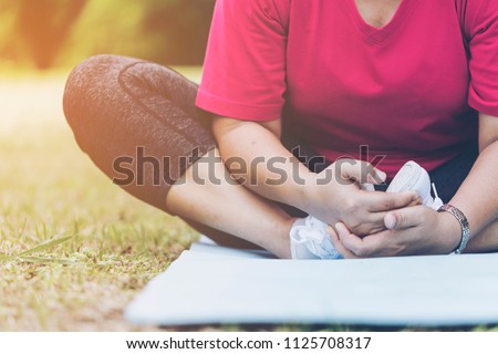 image of woman doing meditation yoga or exercise and relax in nature with copy space,horizontal. lifestyle and peace, soul and mind concept.  sporty attractive female practicing yoga outdoor 