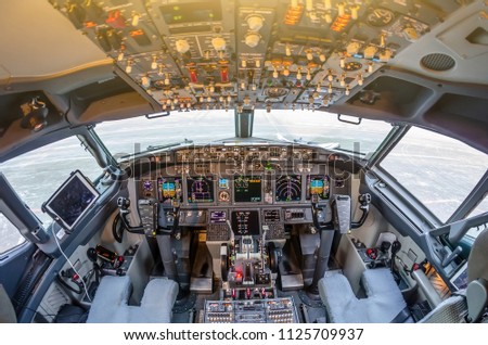 Passenger aircraft interior, engine power control and other aircraft control unit in the cockpit of modern civil passenger airplane Royalty-Free Stock Photo #1125709937