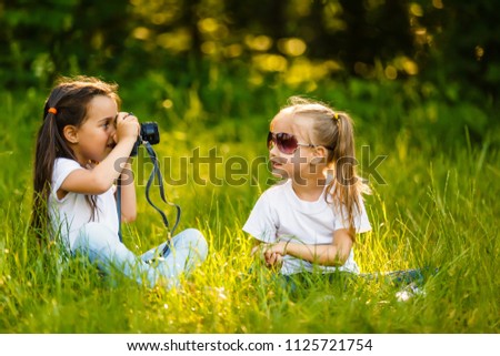 Two children girl hold a camera take a picture each other(together) with smile(happy)