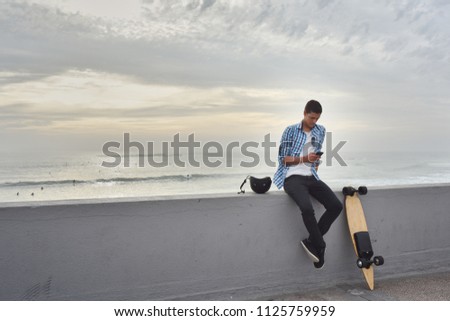 Man with electric skateboard at the beach