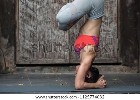 Young healthy woman doing yoga exercises at home.