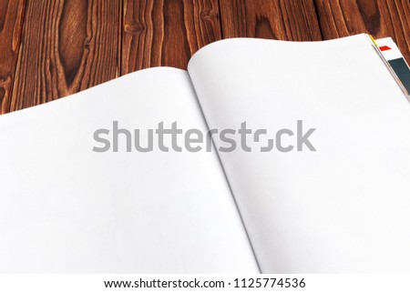 Open blank journal pages for your design copy space on wooden background
