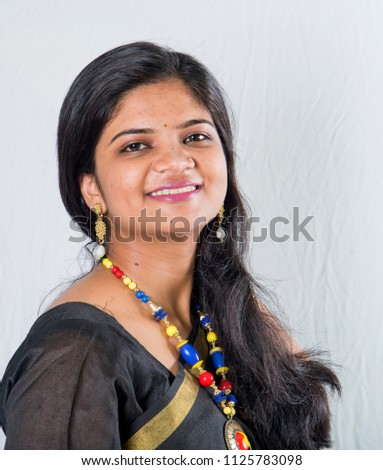 Beautiful smiling Indian girl in black sari.