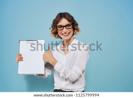 Business woman with glasses shows a sheet of paper in a folder                              