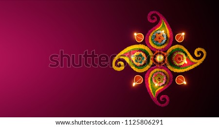 Diwali celebration - Diya oil lamps lit on colorful rangoli Royalty-Free Stock Photo #1125806291
