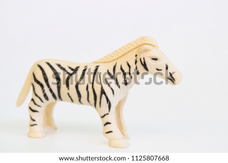 Zebra plastic toys placed on a white background.