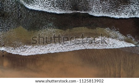 aerial view of waves breaking on a beach. Aerial photo taken from Long Reef Point, Sydney, NSW, Australia 