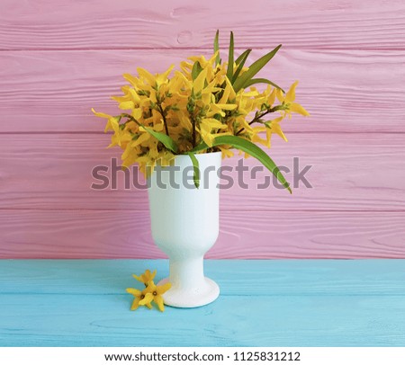 vase yellow flowers on a wooden background autumn