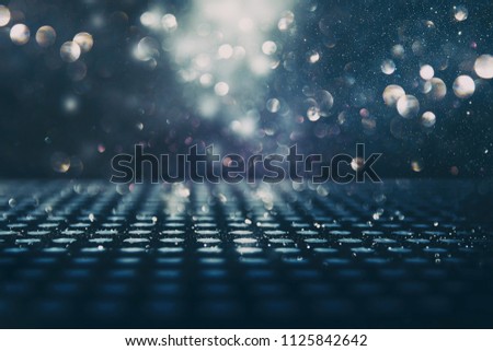 glitter vintage lights background. black, blue, silver and gold. de-focused