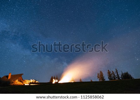 Bonfire under the rising Milky Way.