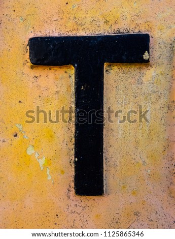 Written Wording in Distressed State Typography Found Letter T