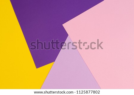 Color papers geometry flat composition background with violet, purple, pink, yellow tones.
