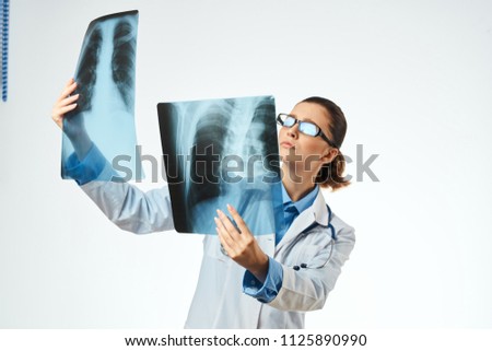    doctor keeps looking at x-ray pictures medical treatment fractures bruises surgeon                            
