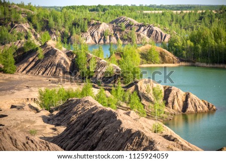 Picture of hilly terrain with green trees and river