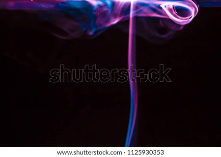 Magical, mystery Abstract colored background. beautiful colorful smoke, ink in water, the patterns of the universe. Abstract movement, frozen multi color flow of paint. 
