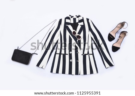 striped clothes with black shoes, handbag ,sunglasses isolated 

