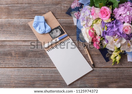 Diary of pregnancy. Still life on wooden boards.