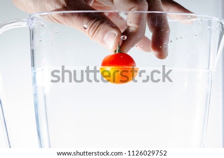 tomato falling into the water still life