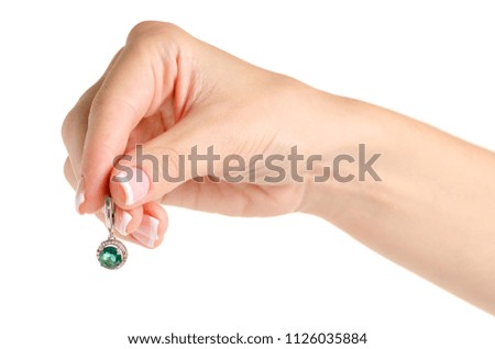 Silver earrings in a hand green stone on a white background isolation