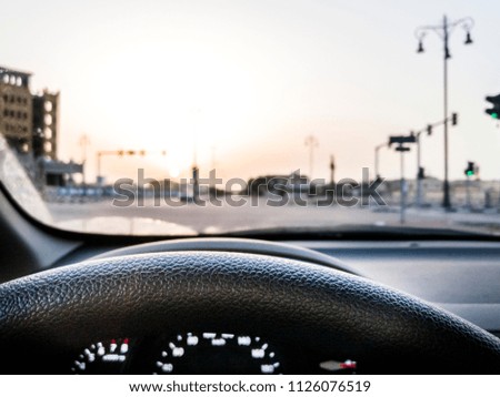 car dashboard and city view and city traffic in the background 