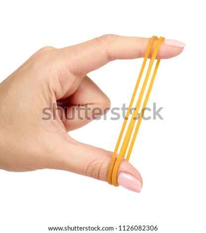 Yellow rubber bands close up with hand isolated on white background