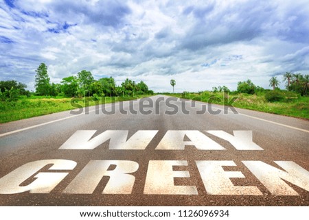 Green Way Sign on the Road with Bright Sky Summer Day, Earth Day and Save the World Concept