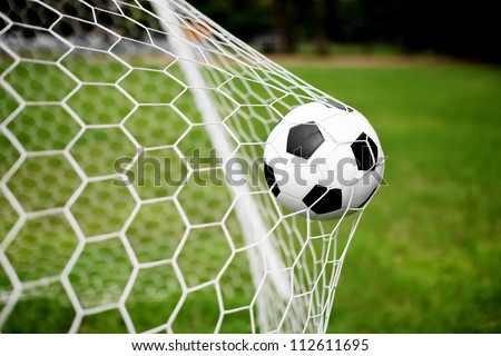 soccer ball in goal net Royalty-Free Stock Photo #112611695