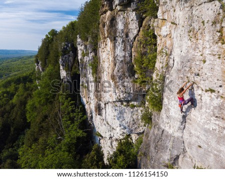 Beautiful woman rock climbing in Ontario, Canada.