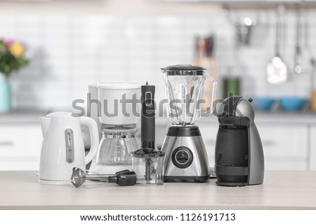 Different modern kitchen appliances on table indoors. Interior element Royalty-Free Stock Photo #1126191713