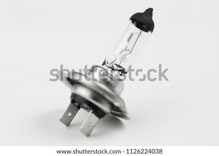 Car bulb on a white workshop table. Electric car accessories. White background.